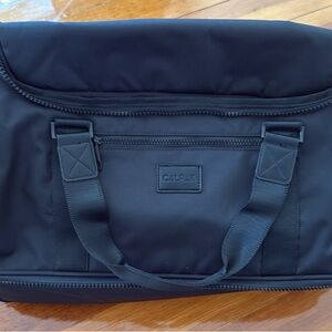Calpak Black Duffel Bag with Durable Fabric and Minimalist Design